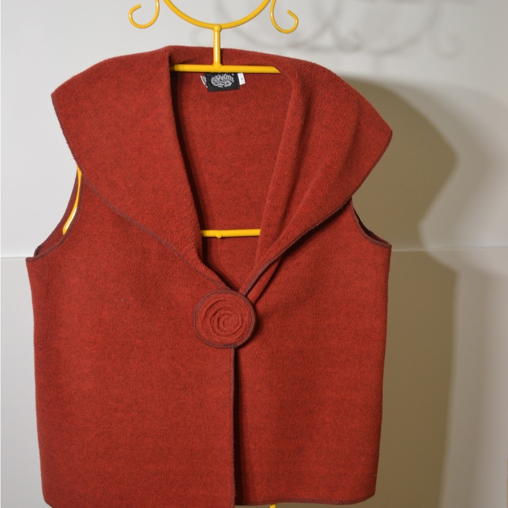 Granny core for Fall. Lovely rust vest with a rosette front clasp. Cowl neck.